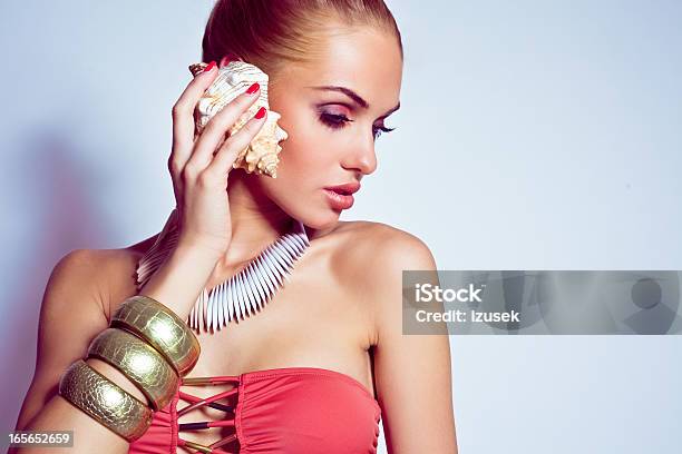Beautiful Woman With A Seashall Stock Photo - Download Image Now - Listening, Women, Animal Shell