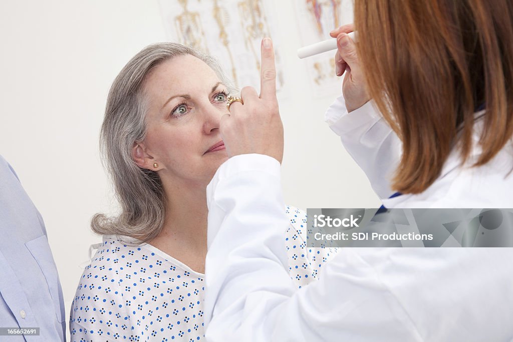 Doctor Giving Exam to Senior Adult Patient Doctor Giving Exam to Senior Adult Patient. Eye Exam Stock Photo