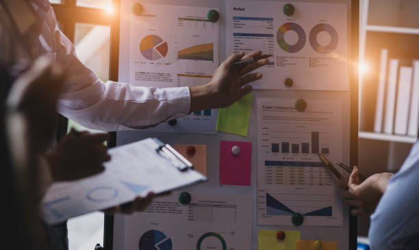 istock Group of  business hands with business financial documents. 1656549290