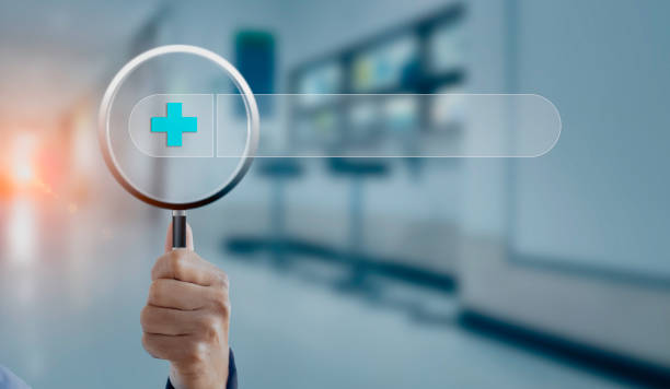 istock Hand holding magnifying glass with medical interface icons. 1656549839