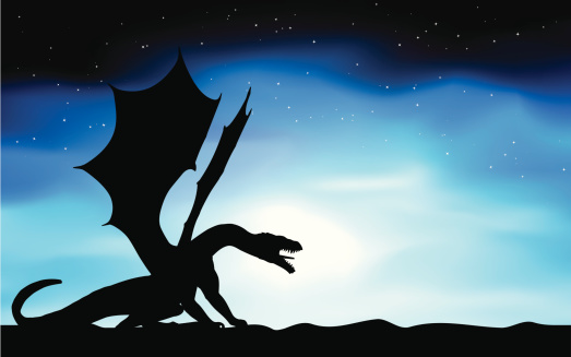 Silhouette of a dragon against a moon lit sky. 