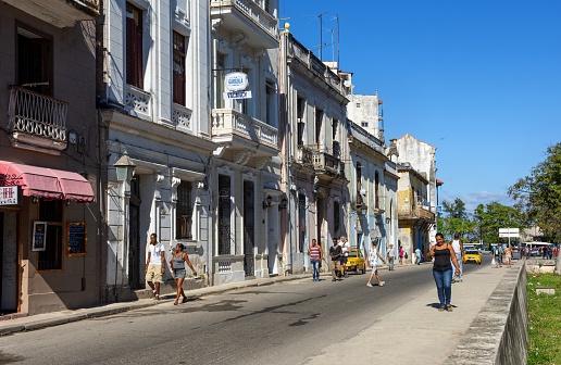 Havana, Cuba, November 20, 2017: The people walk down a street in the center of Havana on a late afternoon.