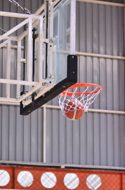 istock Ball hoop into basket in the air 1656635972