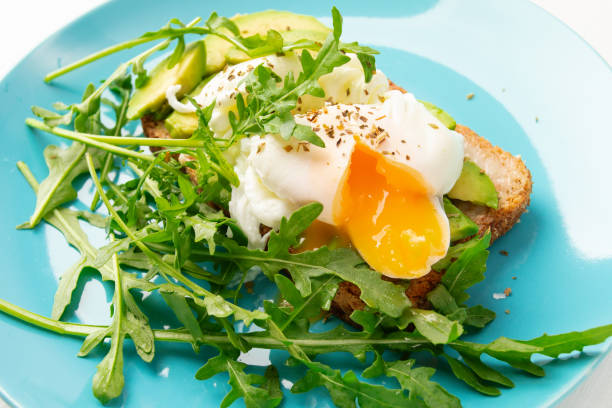 istock Egg Benedict,classic poached egg on toasted bread with avocado and juicy yolk 1656646296
