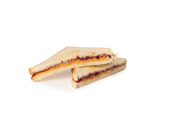 sandwich with peanut butter and raspberry jam isolated,cut in half