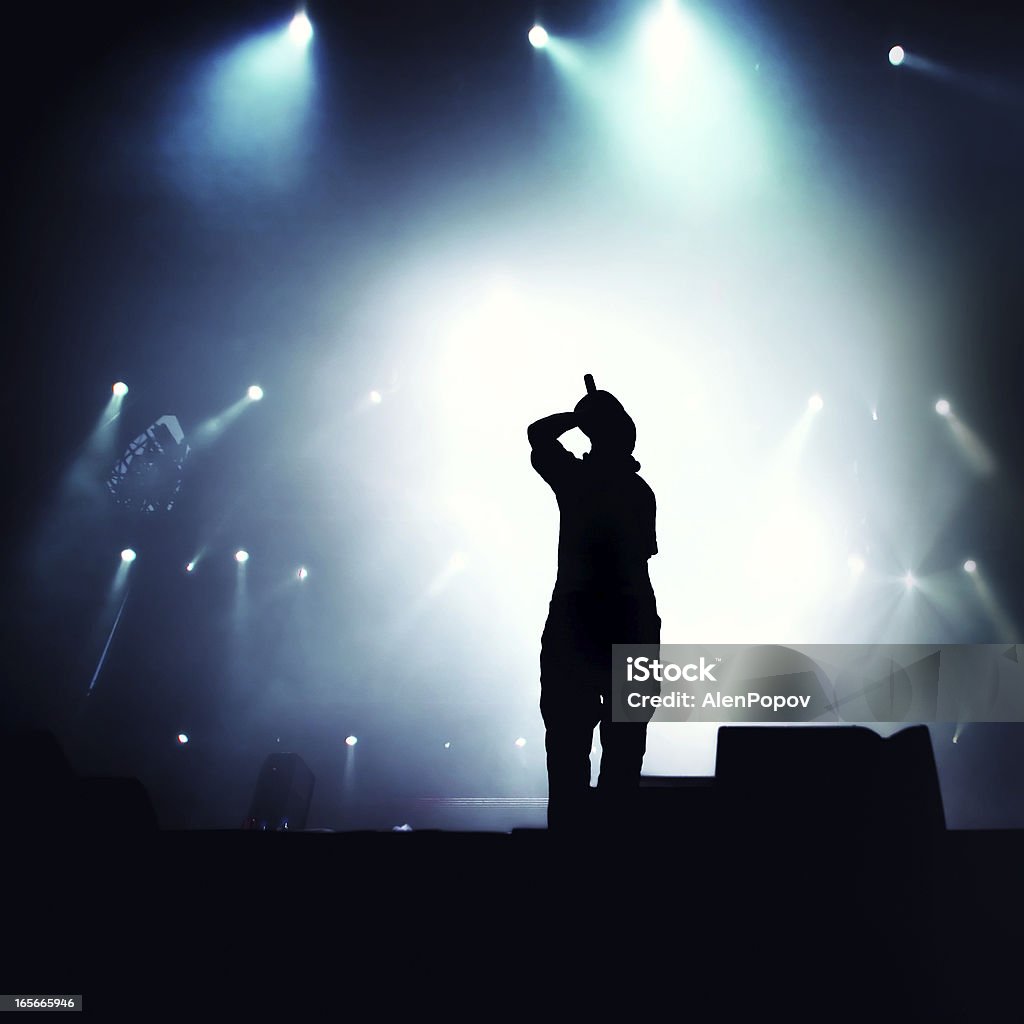 Hip hop singer Silhouette of hip hop singer on stage.  Rap Stock Photo