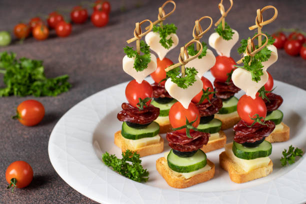 istock Canape with cheese, cherry tomatoes, sausage and black olives 1656664492