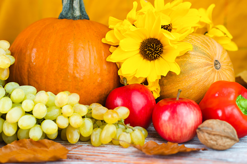 Thanksgiving holiday concept. Seasonal vegetables and fruits on a wooden background. Close-up. Selective focus.