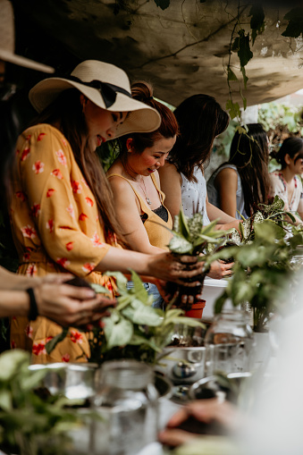 Group of women learning ornamental gardening with Kokedama Japanese technique