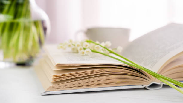 istock Open book and lilies of the valley. Spring composition. Selective focus. 1656670858
