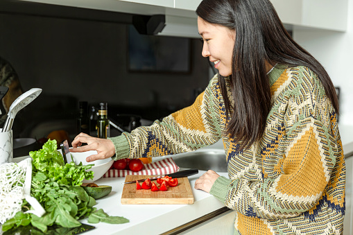 Asian woman making salad. Healthy life style.