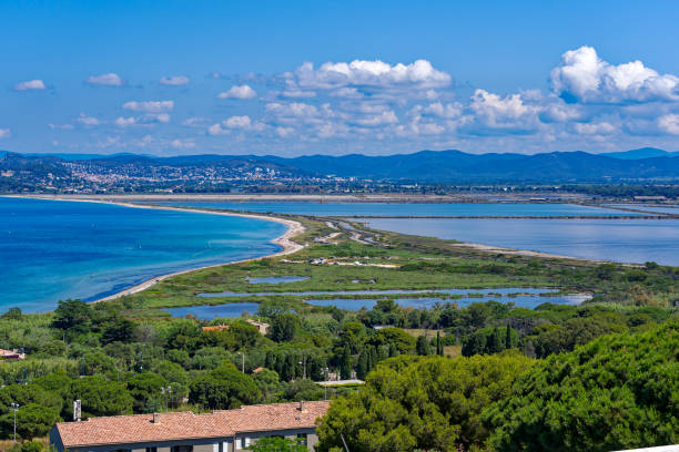 Aerial view of Giens Peninsula with nature reserve and saline. Sunny spring day with Mediterranean Sea, mountain panorama and seashore in the background at southern France. Photo taken June 8th, 2023, Giens, France. peninsula stock pictures, royalty-free photos & images