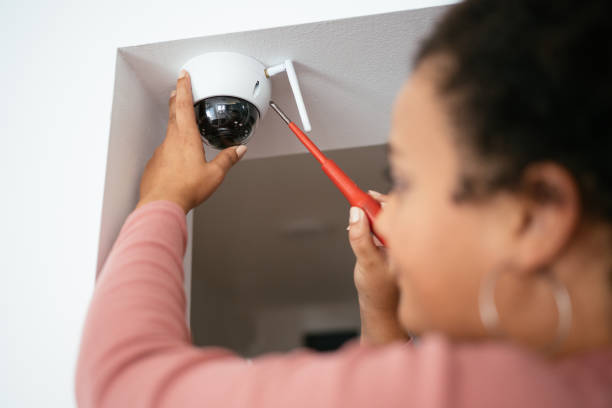 istock Young Latin woman installing video surveillance at home 1656688050