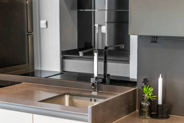 istock Kitchen sink with black tiles in condo 1656701414