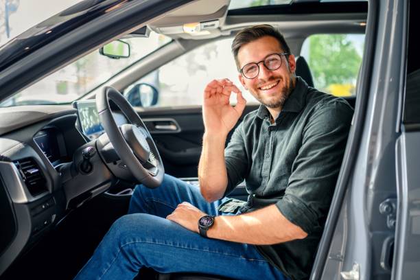 Portrait of a happy customer buying a new car stock photo