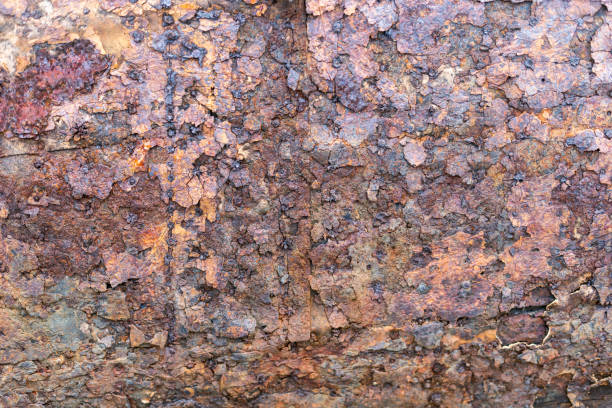 istock Heavily worn rusty iron surface nailed to a wooden surface 1656707747