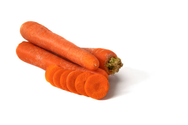 Carrots isolated on a white background. Carrots are crunchy, orange roots, loaded with beta carotene and sweet flavor, perfect for salads and healthy snacks.