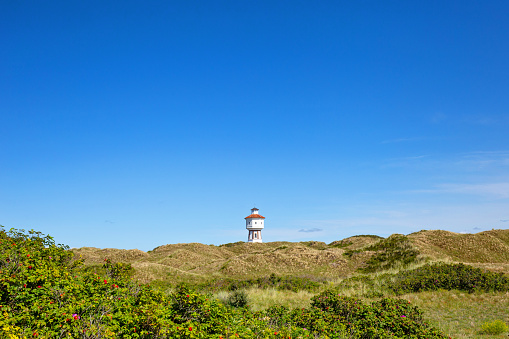 Nationalpark Langeoog and Water Tower On The East Frisian Island Langeoog  on a beautiful sunny summer day with clear blue sky