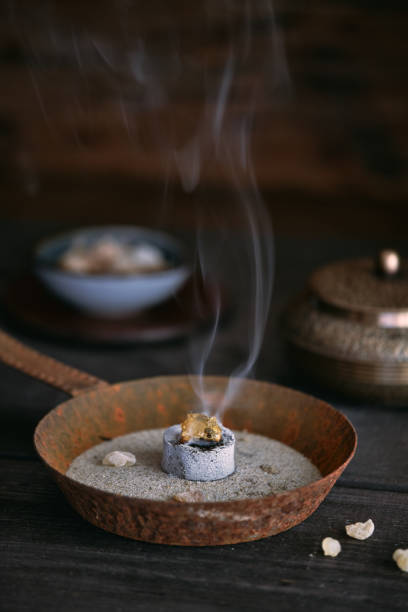 istock Incense resin (olibanum) burning on a glowing incense charcoal 1656728602