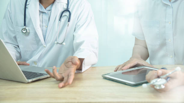 istock Smart medicine doctors working with computer notebook and digital tablet  at desk in the hospital. Medical concept.Medical teamwork discussion 1656739906