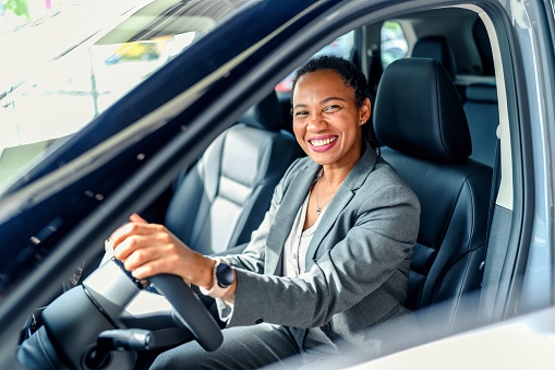 Portrait of a happy customer buying a new car