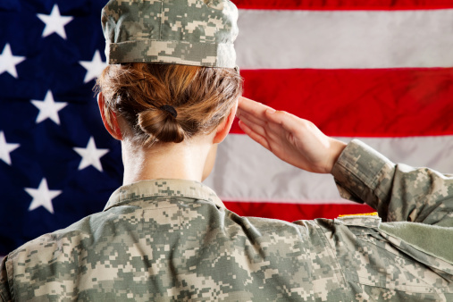 Female American soldier standing & saluting.