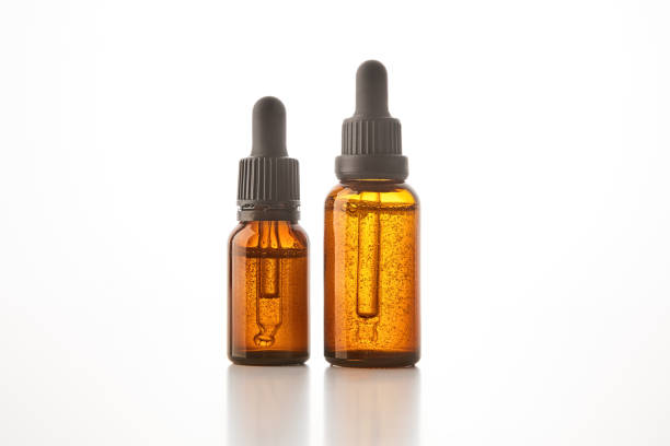 istock Two brown vials with black dropper caps isolated on white. 1656778597