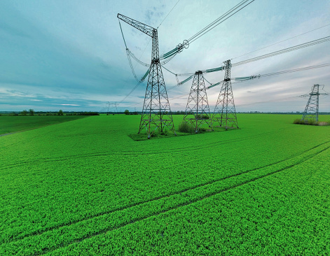 High voltage tower construction in green gield, beautiful landscape, blue sky, clean energy. global warming. download photo