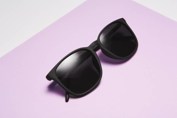istock Sun glasses, folded shades lie diagonally on light violet. 1656789461