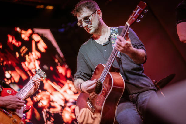istock Band performs on stage, rock music concert. 1656804976