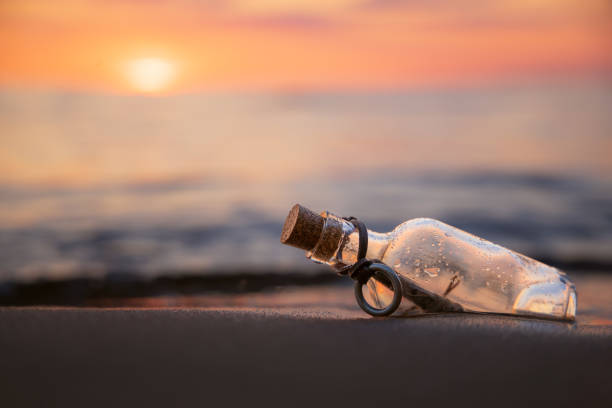 istock Message in the bottle against the Sun setting down 1656804978
