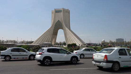Iranian Cars passing by the Azadi Tower in Tehran, Iran on September 1st, 2023