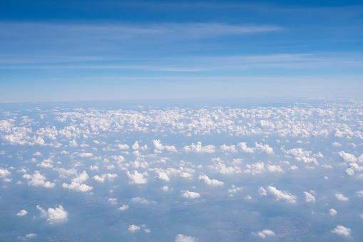 Clouds above the Aerial view view from airplane window. Nature background.