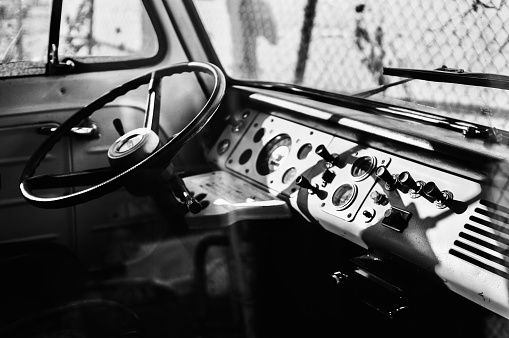 The dashboard of a vintage Ford Econoline Van in black and white