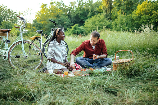 Loving couple is enjoying a picnic outdoors