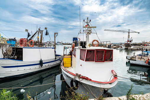 Fishing ships an old boats in the trading port of Sciacca, fishing village in Sicily, Italy