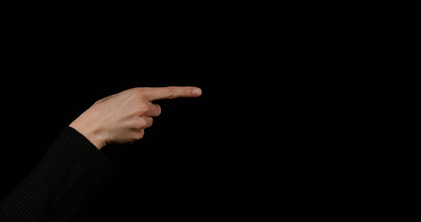 istock Hand of Woman making Sign against Black Background 1656899430