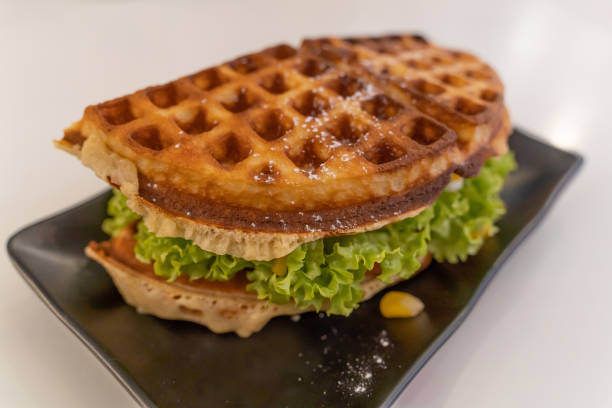 istock Sweet corn waffle with tomato, mayonnaise, chili sauce and lettuce. 1656917563