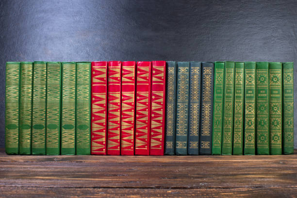 istock Old books on a wooden shelf. No labels, blank spine. 1656926656