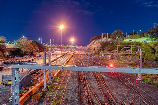 The railway tracks in Mechanics Bay in Auckland closest is illuminated at night