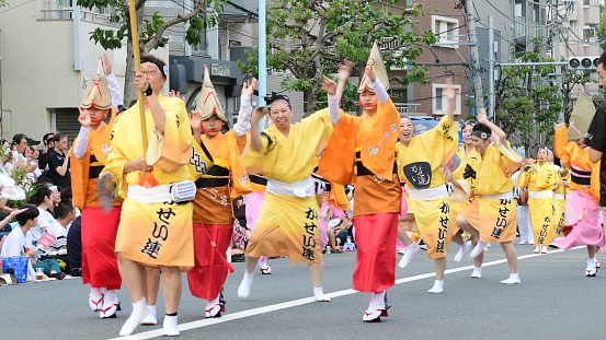 Tokyo, Japan-August 27, 2023:\nKoenji Awa Dance Festival in Suginami Ward, Tokyo, which takes place annually on the last weekend of August, is one of the most popular festivals outside Tokushima City. Over 100 groups of dancers participate in the festival, which proceed dancing on the main streets around JR Koenji Station in the evening.\nAwa Dance Festival, which originated, and takes place during August 12-15, in Tokushima City of Shikoku Island, is now widely practiced in many parts of Japan. By moving arms and legs freely, men express braveness and humor and women express elegance and amorousness.\nAwa Dance Festival is one of the three most famous Bon Dance Festivals in Japan and has a history of over 400 years.