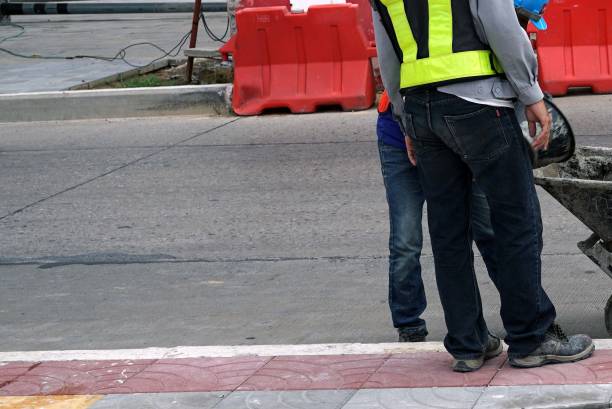 istock Worker at work on a road construction site, closeup of photo 1656974450
