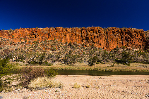 Glen Helen Gorge is a pretty place in Australia with high rocks around a waterhole. You can hike, swim, and watch sunsets there. People visit for nature and relaxing.