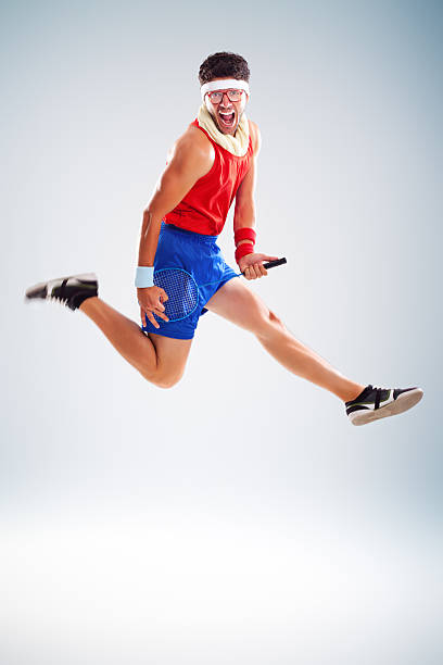 istock Fitness man jumping with tennis racket 165698801