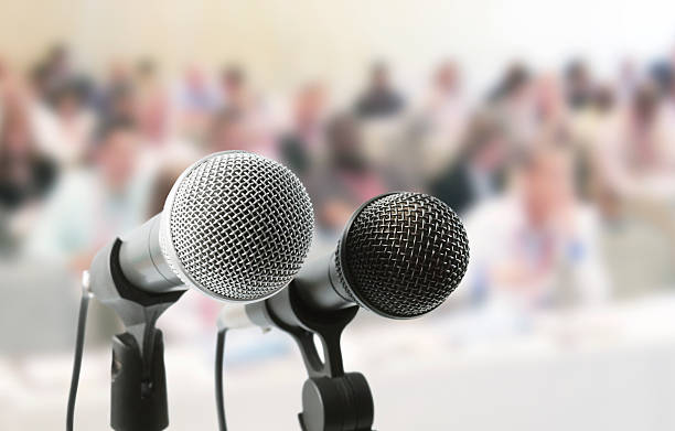 istock Two microphones await a speaker at meeting in auditorium 165699252