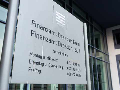 Dresden, Finanzamt (tax office) information sign with the office hours of the District Dresden Nord (north) and Süd (south). Opening times of the financial authority.