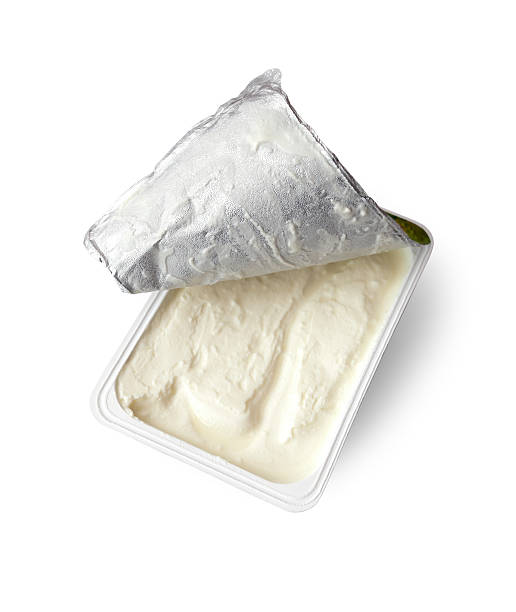 just opened box cream cheese, isolated on white Studio shot of a just opened box cream cheese, isolated on white, clipping path includet. opened box cream cheese isolated on white background.white plastic box. White, nahaufnahme, niemand, single onject cream cheese photos stock pictures, royalty-free photos & images