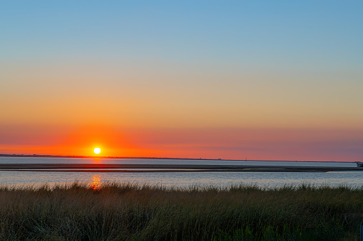 The sun setting over Sandy Hook Bay in Gateway National Recreation Area in New Jersey.