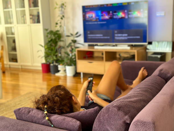 istock Woman watching television at home. 1657011380