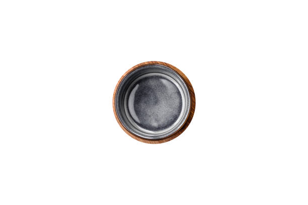 istock Empty round ceramic bowl on a wooden cutting board in brown color 1657016991